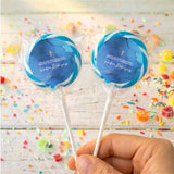 Personalised lollipops with deep blue round labels, gold cross, clear wrappers, white sticks