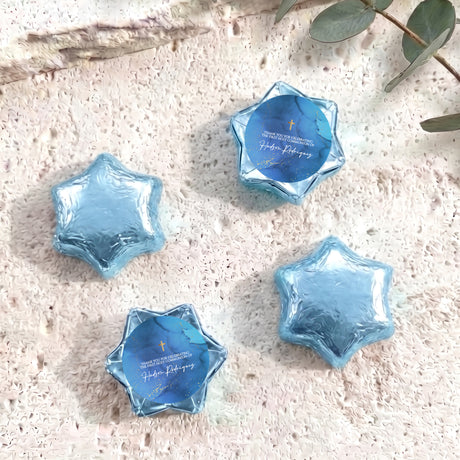 Light blue foil chocolate star with blue personalised label and gold cross detail