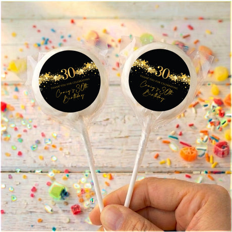 Black 30th birthday lollipops with gold “30” star print, clear wrap, two sticks
