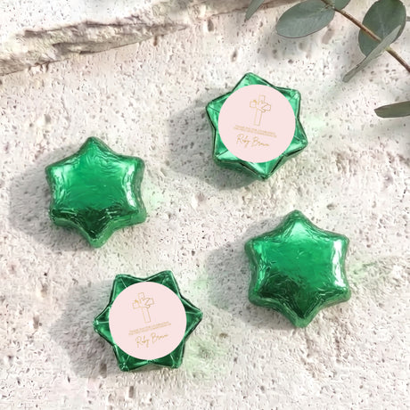 Green foil chocolate stars with round personalised label and small cross emblem