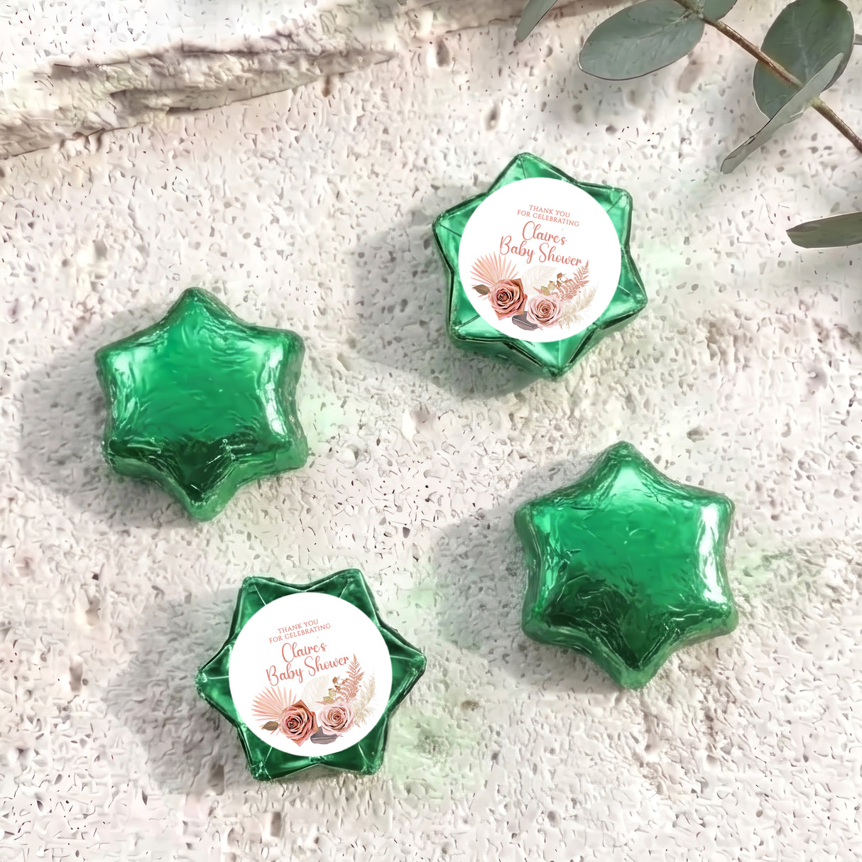 Green foil-covered chocolate stars with round 'Baby Shower' label