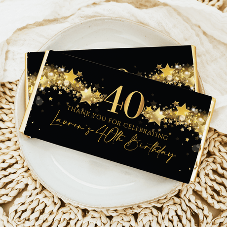 Black chocolate bar wrapper with gold stars and 40th birthday text