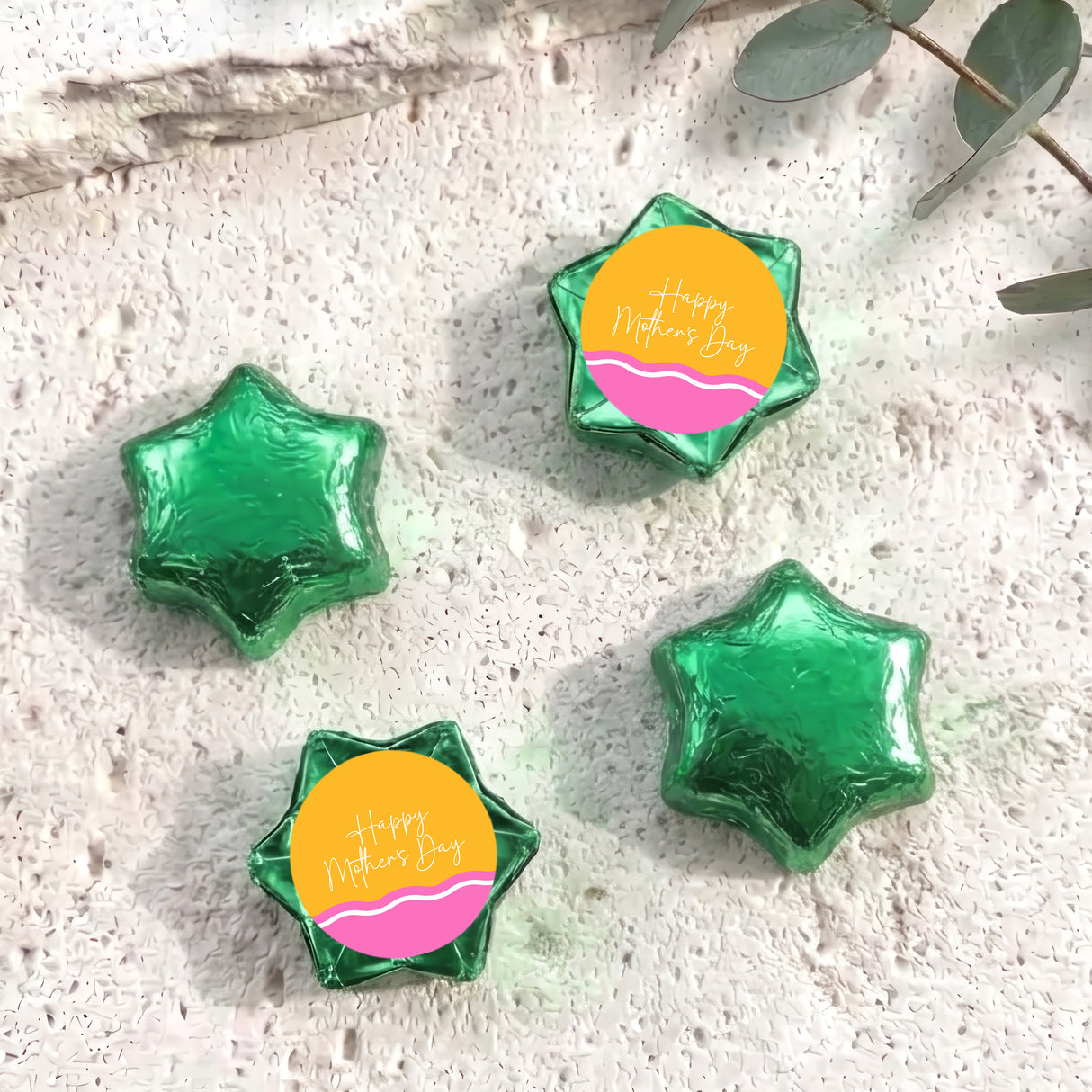 Green foil star chocolates with “Happy Mother’s Day” label, arranged in set.