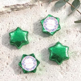Foil-covered chocolate stars in green with printed pastel border