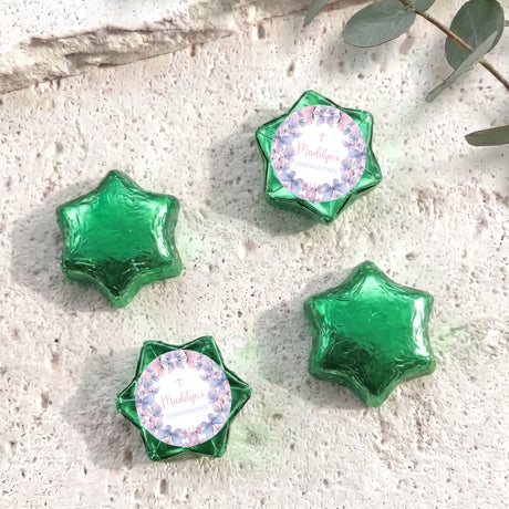 Foil-covered chocolate stars in green with printed pastel border