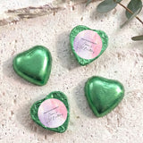 Foil-covered chocolate hearts, green heart-shaped chocolates with a round label on top