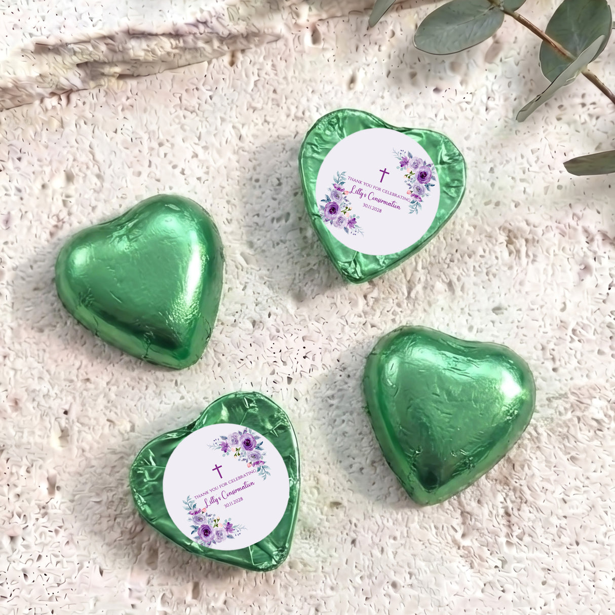 Foil-covered chocolate hearts, green with confirmation floral design on heart