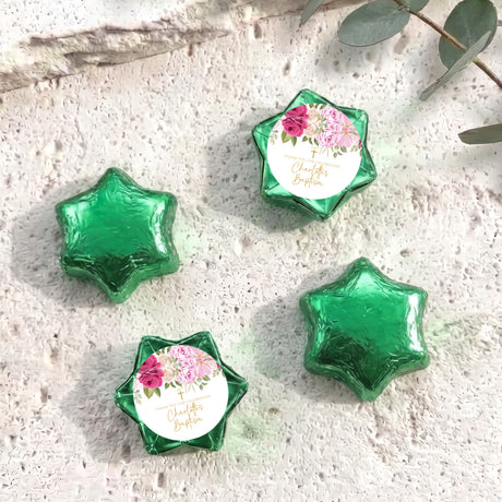 Foil-covered chocolate stars with floral personalized label, green foil shapes