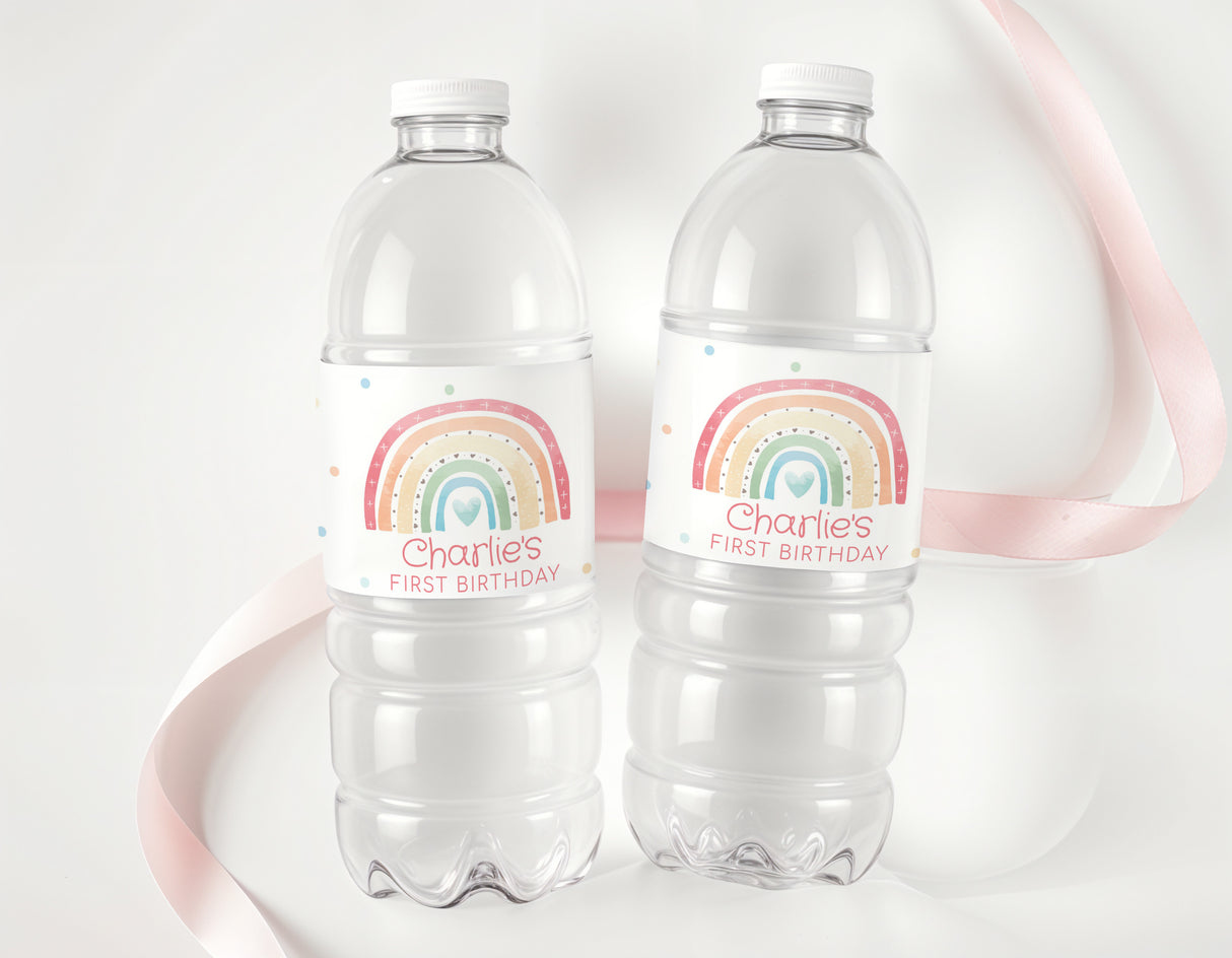 Personalised first birthday water bottle labels with rainbow boho design on two clear bottles