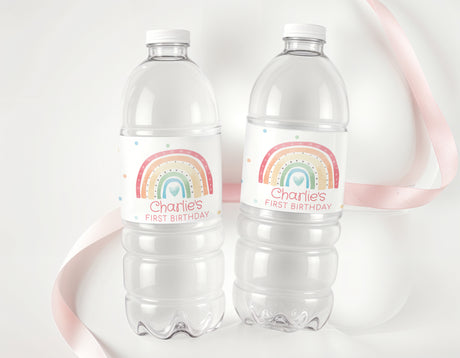 Personalised first birthday water bottle labels with rainbow design on clear bottles