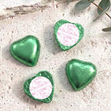 Green foil-covered chocolate hearts with personalised christening message labels