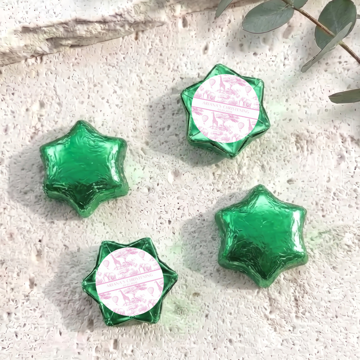 Green foil-covered chocolate stars with personalized white center foil