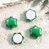 Green foil-covered chocolate stars with personalized white center foil