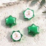 Green star-shaped foil balloons with 'Charlotte's Baby Shower' teddy design