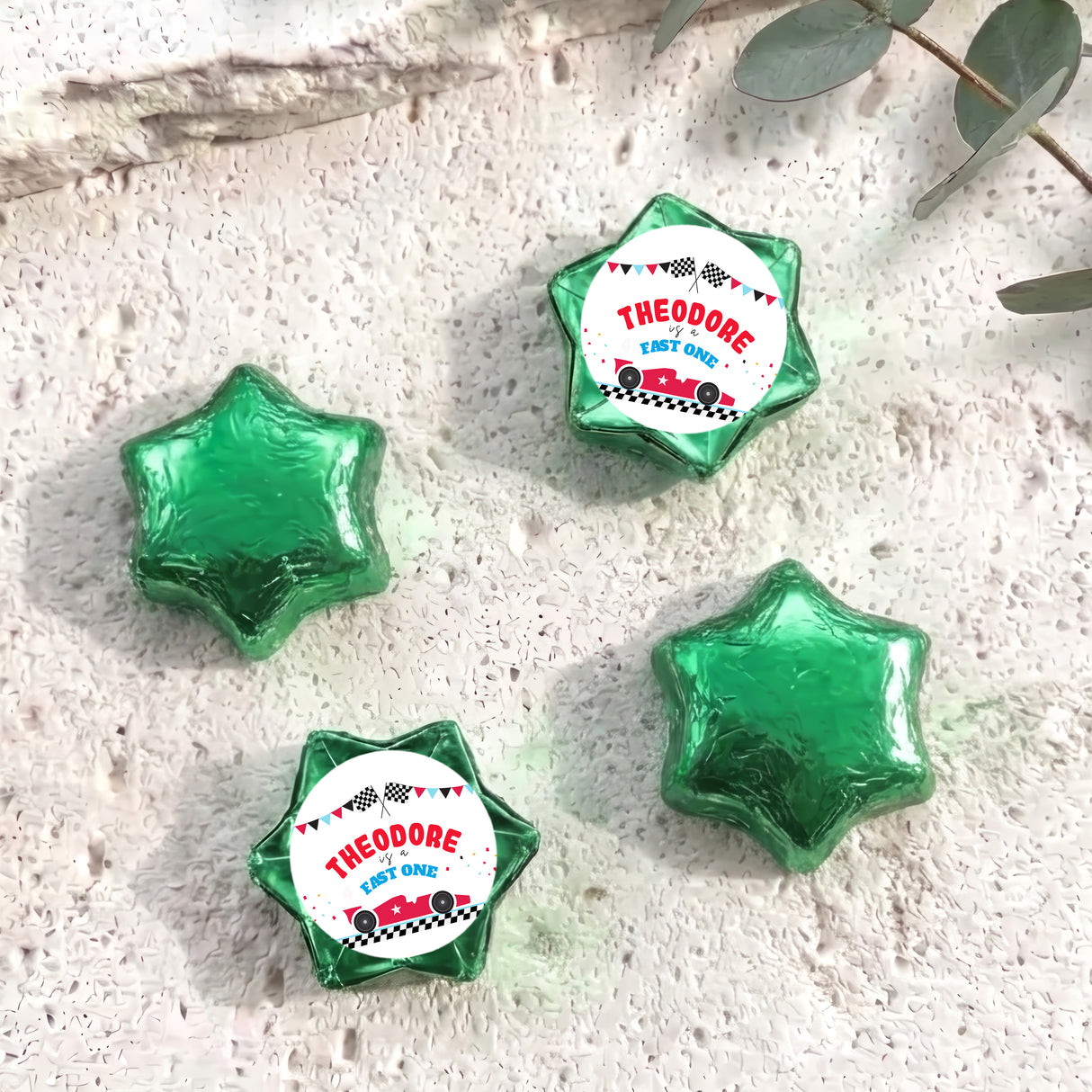Personalised foil chocolate star set with green foil and “THEODORE” label