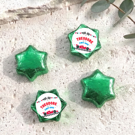 Green foil-covered chocolate star sweets with personalized "THEODORE" label