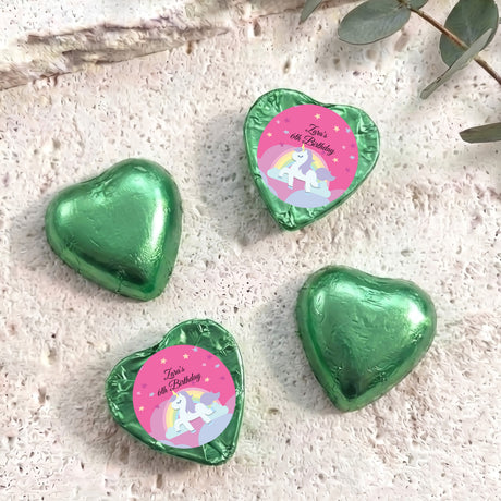 Green foil chocolate hearts with unicorn “Zara’s 6th Birthday” label.