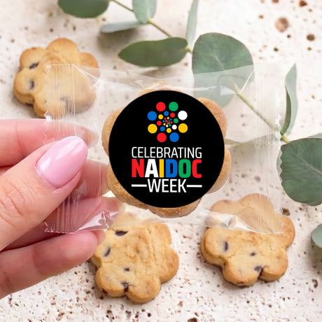 Bite-size choc chip cookies with black Naidoc Week round sticker