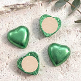 Green foil-covered chocolate hearts with beige round labels and heart shapes
