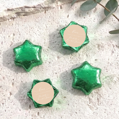 Foil-covered star chocolates with green finish and round personalized tag
