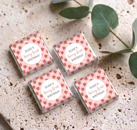 Set of four personalised mini chocolate boxes with strawberry print and 'Berry First Birthday' label
