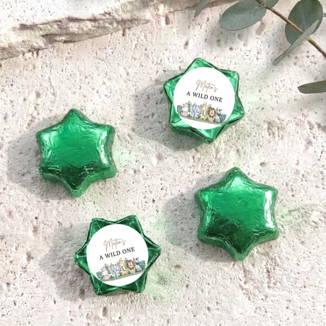 Green foil-covered chocolate stars with round label reading “A WILD ONE”