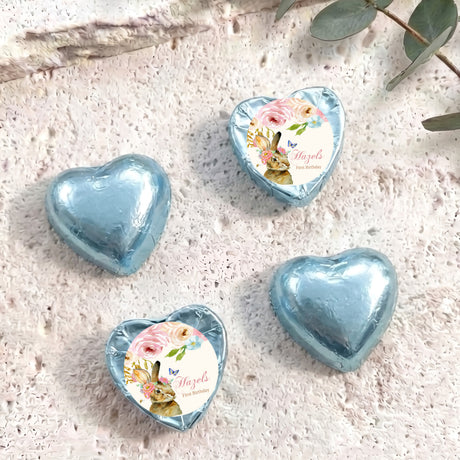 Light blue foil-covered chocolate hearts with floral wrapped center medallions