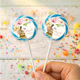Personalised bunny floral lollipops with blue-bordered round labels, held in hand