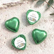 Green foil-covered chocolate hearts with white 'A WILD ONE' labels