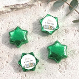 Foil-covered chocolate stars, green with "A WILD ONE" label on center star