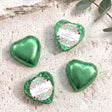 Green foil-covered chocolate hearts, three hearts with personalised First Holy Communion label