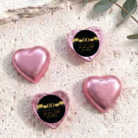 Pink foil heart chocolates with black 90 birthday label and gold star text