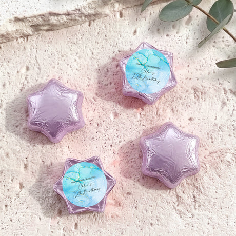 Foil-covered chocolate stars in purple foil, four star shapes