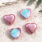 Foil-covered chocolate hearts in pink with personalized blue label on top