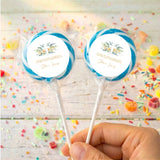 Personalised lollipops with floral cross labels, blue accent, clear wrap, hand held