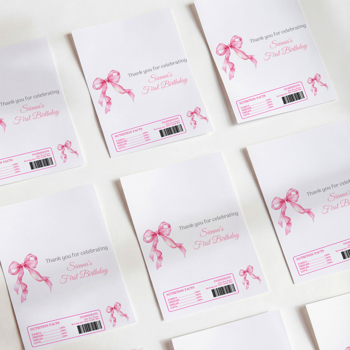 Pink first birthday DIY printed chocolate wrappers with ribbon bow and barcode labels