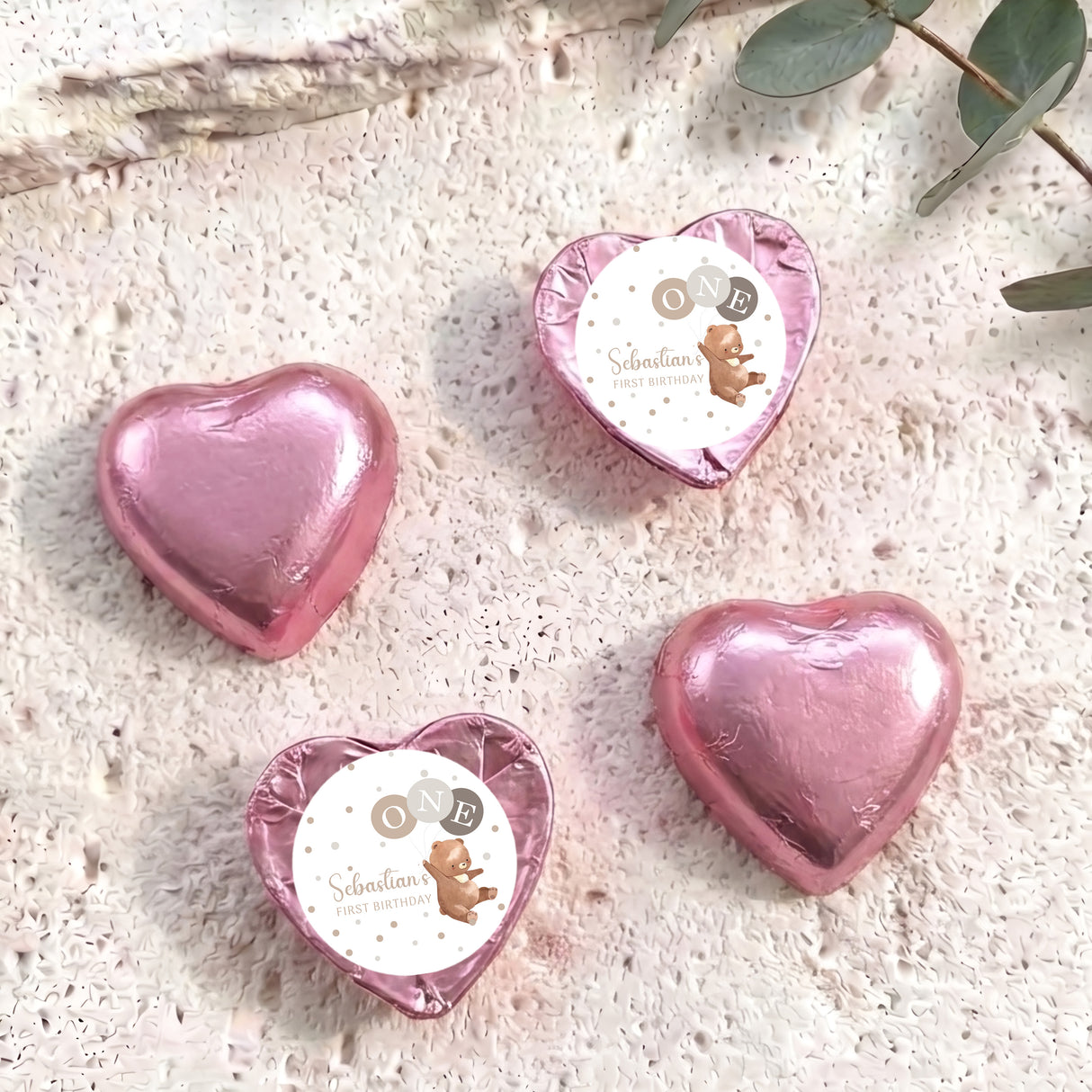 Foil-covered chocolate hearts, pink heart balloons in a set of four