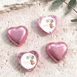 Foil-covered chocolate hearts, pink heart balloons in a set of four