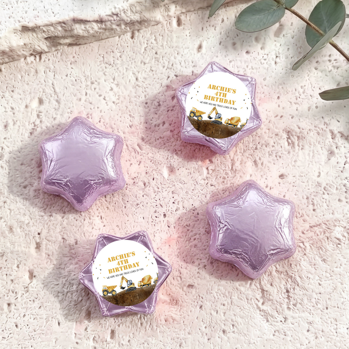 Foil-covered chocolate star sweets in pale purple, with birthday foil label