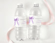 Clear water bottles with purple bow labels, personalised thank-you for First Birthday
