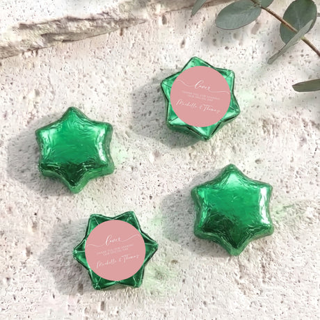 Green foil-covered chocolate stars, star-shaped foil chocolates with round label.