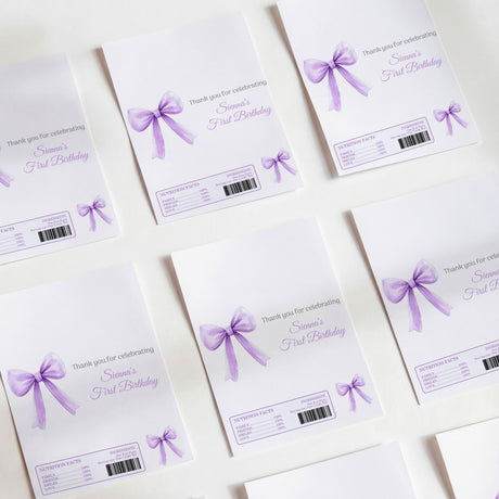 Purple first birthday printed chocolate wrappers with bow and barcode labels