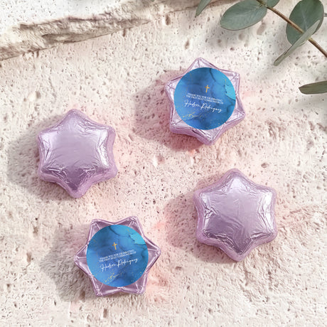 Purple/lilac foil chocolate stars with blue personalised label and gold cross