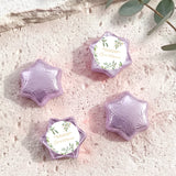 Foil-covered chocolate stars with purple wrappers and a personalized cream label.