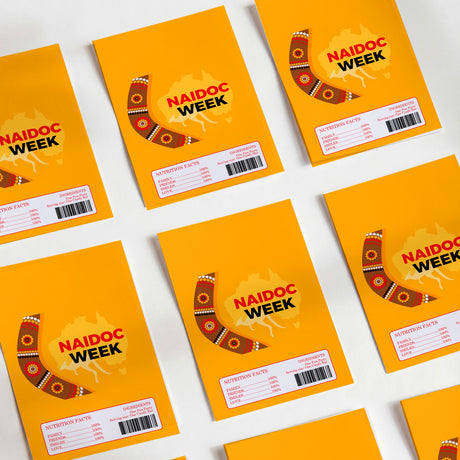 Orange NAIDOC Week DIY chocolate wrapper with boomerang-style artwork and label