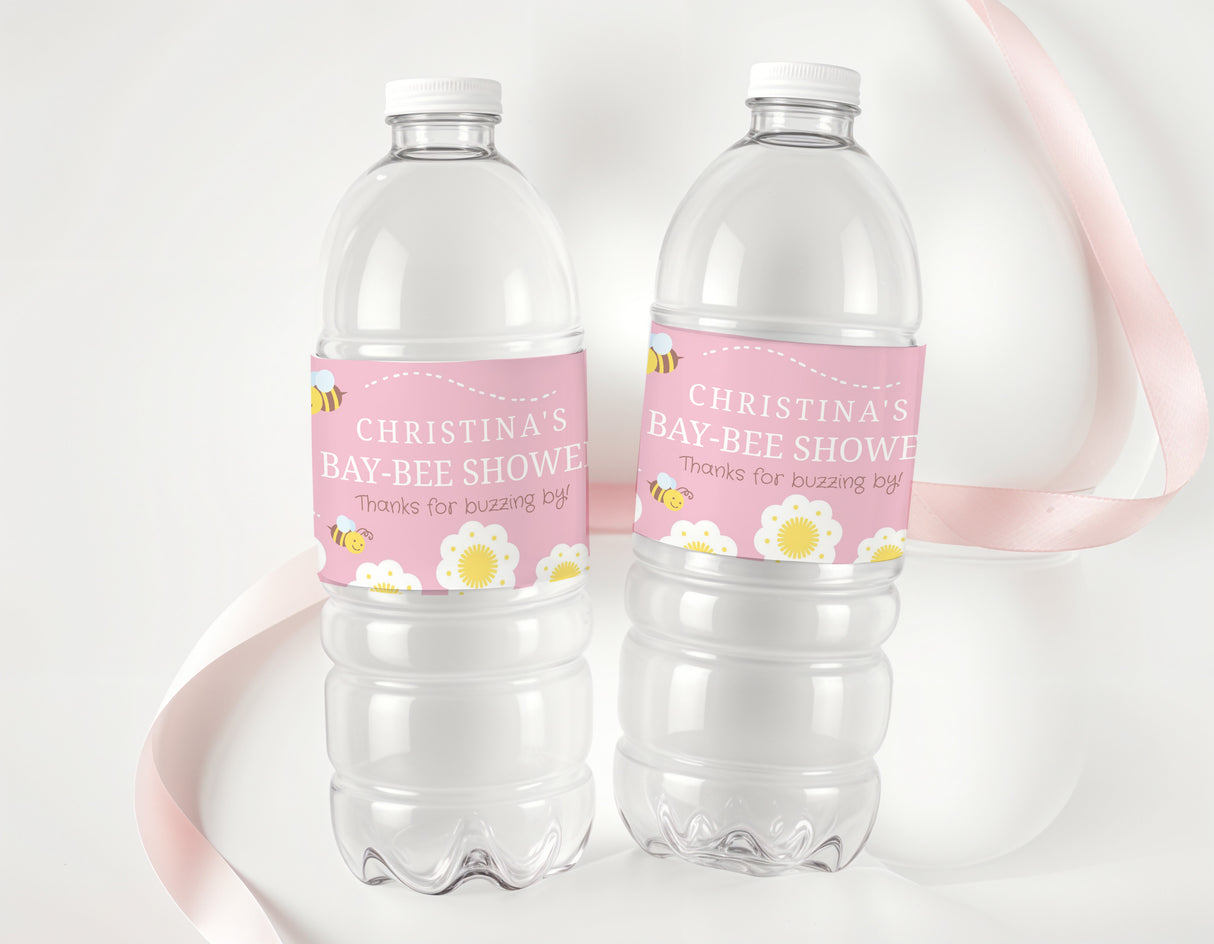 Two clear plastic water bottles with pink personalised shower labels and bee design