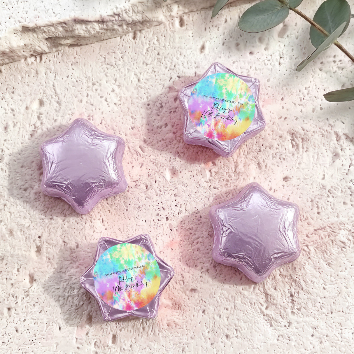 Foil-covered chocolate stars: purple foil stars with one rainbow tie-dye star