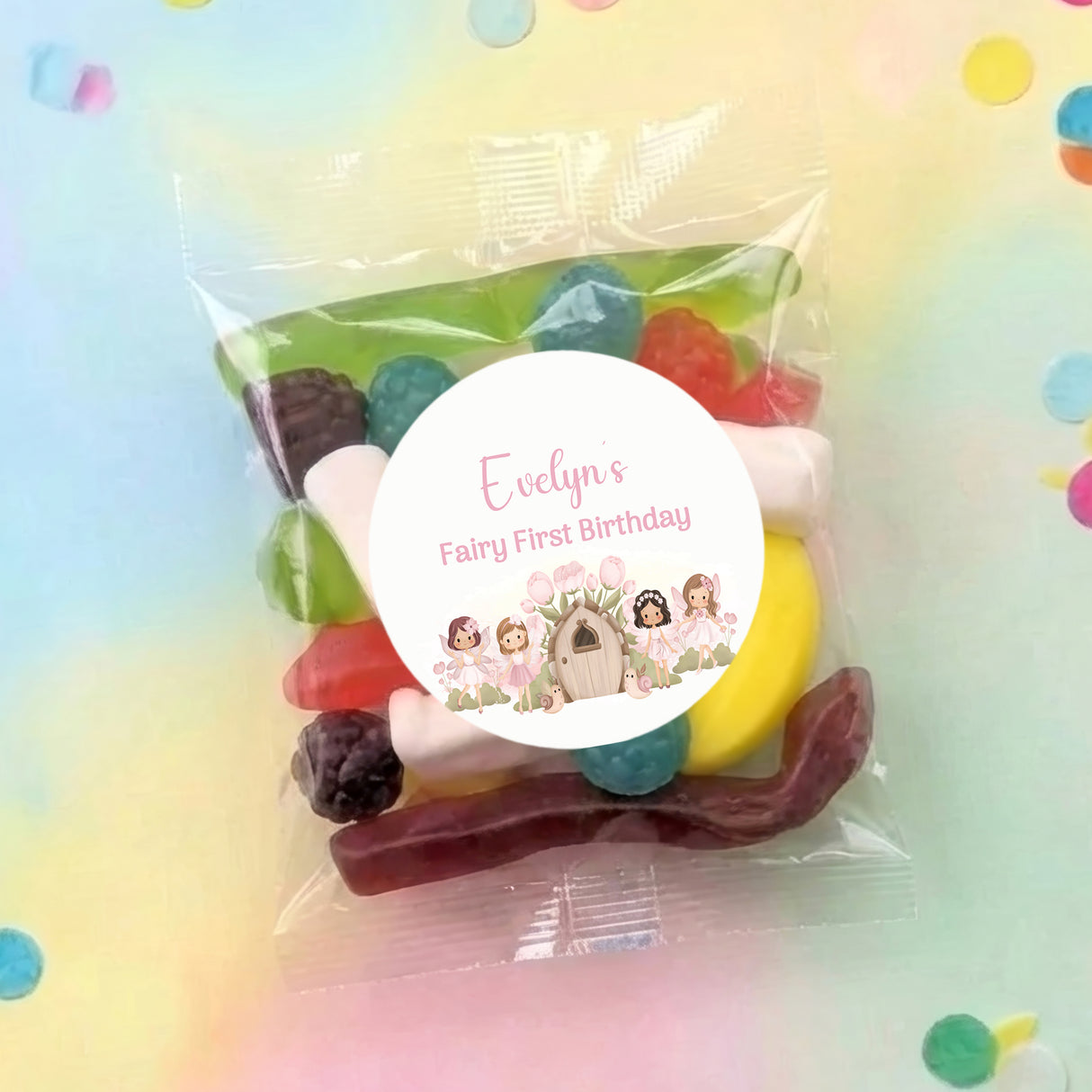 Personalised fairy-themed lolly bag, clear wrapper with round label and assorted sweets inside.
