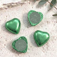 Green heart-shaped foil-covered chocolate with round thank-you label