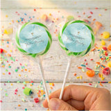 Green-bordered christening lollipops with gold cross and printed names on round wrappers